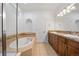 A bright bathroom offers a soaking tub, double sink vanity, and tile accents at 4400 S Ensenada St, Aurora, CO 80015
