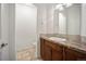 Bright powder room features tile floor, vanity, sink, and toilet at 4400 S Ensenada St, Aurora, CO 80015