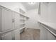 Organized walk-in closet featuring built-in shelving, cabinets, and ample storage space at 4400 S Ensenada St, Aurora, CO 80015
