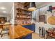 L-shaped basement bar with brick wall and blue cabinetry at 5224 Knobcone Dr, Castle Rock, CO 80108