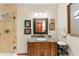 Bathroom with granite vanity, glass shower, and decorative framed artwork at 5224 Knobcone Dr, Castle Rock, CO 80108