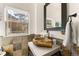 Bathroom featuring a unique wood vessel sink and a frameless mirror at 5224 Knobcone Dr, Castle Rock, CO 80108