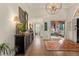 Bright entryway with hardwood floors, decorative console table, and access to other rooms at 5224 Knobcone Dr, Castle Rock, CO 80108