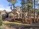 House nestled among tall trees with a landscaped yard at 5224 Knobcone Dr, Castle Rock, CO 80108