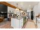 Modern kitchen with green range and brick floor at 5224 Knobcone Dr, Castle Rock, CO 80108