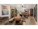 Rustic office with wood desk, leather chairs, and built-in shelving at 5224 Knobcone Dr, Castle Rock, CO 80108