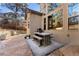 Rustic wooden patio table with benches, located adjacent to the house at 5224 Knobcone Dr, Castle Rock, CO 80108