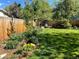 This backyard has a lush garden and a fenced perimeter at 6705 Youngfield Ct, Arvada, CO 80004