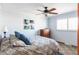 This bedroom offers a ceiling fan and bright natural light from the window at 6705 Youngfield Ct, Arvada, CO 80004