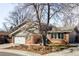 Charming home with a well-kept lawn, mature trees, and a two-car attached garage at 6705 Youngfield Ct, Arvada, CO 80004