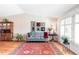 Cozy living room with hardwood floors, large windows, and traditional decor at 6705 Youngfield Ct, Arvada, CO 80004