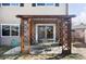 This home has a covered patio space with string lights and an outdoor dining set at 6705 Youngfield Ct, Arvada, CO 80004