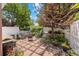 Charming backyard with stone patio, white fence, and well-manicured landscaping at 2528 Concord Cir, Lafayette, CO 80026