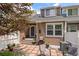 Private backyard with a stone patio, grill, and lush greenery at 2528 Concord Cir, Lafayette, CO 80026
