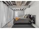 Cozy basement bedroom featuring modern decor, exposed ceiling, and comfortable gray bed at 2528 Concord Cir, Lafayette, CO 80026
