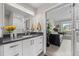 Bathroom with a sleek vanity, modern mirror, and a glimpse into the bedroom at 2528 Concord Cir, Lafayette, CO 80026
