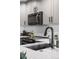 Modern kitchen features sleek black hardware, stainless steel microwave, and bright subway tile backsplash at 2528 Concord Cir, Lafayette, CO 80026