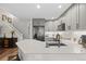 Stylish kitchen featuring grey cabinets, stainless steel appliances, and an expansive island with granite countertops at 2528 Concord Cir, Lafayette, CO 80026