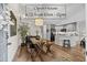 Bright living room boasts wooden floors, a modern kitchen with grey cabinets, and a staircase to the upper level at 2528 Concord Cir, Lafayette, CO 80026