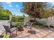 Cozy backyard patio with stone pavers, outdoor seating, and lush landscaping at 2528 Concord Cir, Lafayette, CO 80026