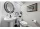 Stylish powder room features shiplap walls, decorative mirror, and elegant fixtures at 2528 Concord Cir, Lafayette, CO 80026