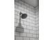 Close-up of a modern shower head with white subway tile at 2528 Concord Cir, Lafayette, CO 80026