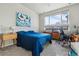 Bedroom featuring large window with views of trees and blue comforter at 9291 Twenty Mile Rd # 106, Parker, CO 80134