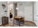 Dining area featuring a modern table, pendant lighting, and a convenient bathroom nearby at 9291 Twenty Mile Rd # 106, Parker, CO 80134