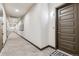 Long hallway with neutral colors, carpet, art and an exit sign in a condominium for sale at 9291 Twenty Mile Rd # 106, Parker, CO 80134