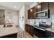 Modern kitchen featuring granite countertops, stainless appliances, and open access to the dining area at 9291 Twenty Mile Rd # 106, Parker, CO 80134