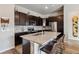 Modern kitchen with stainless steel appliances, granite countertops, and dark wood cabinets at 9291 Twenty Mile Rd # 106, Parker, CO 80134