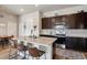 Kitchen featuring a large island with granite countertops and seating, stainless steel appliances, and wooden floors at 9291 Twenty Mile Rd # 106, Parker, CO 80134