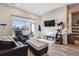 Bright living room with sliding glass doors to a private balcony; view of cat tree at 9291 Twenty Mile Rd # 106, Parker, CO 80134