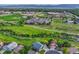 A scenic aerial view of the neighborhood, showcasing the lush greenery and nearby community buildings at 1838 Mountain Daisy Ct, Highlands Ranch, CO 80129