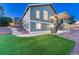 Grassy backyard with steps leading up to a covered deck at 1838 Mountain Daisy Ct, Highlands Ranch, CO 80129