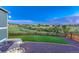 An inviting backyard displaying a manicured lawn area bordered by decorative gravel and a wooden fence at 1838 Mountain Daisy Ct, Highlands Ranch, CO 80129