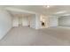 Spacious basement featuring neutral carpeting, recessed lighting, and open layout with adjacent kitchen at 1838 Mountain Daisy Ct, Highlands Ranch, CO 80129
