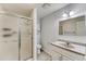 Bright bathroom featuring a walk-in shower with glass doors, tile flooring, and vanity at 1838 Mountain Daisy Ct, Highlands Ranch, CO 80129