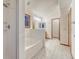 Bathroom featuring a walk-in shower, soaking tub, double-sink vanity, and tile flooring at 1838 Mountain Daisy Ct, Highlands Ranch, CO 80129