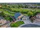Aerial view showcases a well-maintained home with mature landscaping, a driveway, and a two car garage at 1838 Mountain Daisy Ct, Highlands Ranch, CO 80129