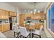 Charming kitchen with stainless steel appliances, wooden cabinetry, stylish backsplash, and a large window at 1838 Mountain Daisy Ct, Highlands Ranch, CO 80129