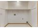 A well-lit laundry room with tile floors, overhead lighting and a storage shelf at 1838 Mountain Daisy Ct, Highlands Ranch, CO 80129