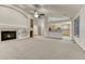 Large living room features a fireplace, built-in shelves, and an open concept kitchen at 1838 Mountain Daisy Ct, Highlands Ranch, CO 80129