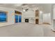 Spacious living room with built-in shelves, fireplace, and large sliding glass doors at 1838 Mountain Daisy Ct, Highlands Ranch, CO 80129