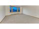 Bright, carpeted living room with large bay windows for natural light at 1838 Mountain Daisy Ct, Highlands Ranch, CO 80129