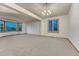 Spacious living room with neutral carpet and bay windows at 1838 Mountain Daisy Ct, Highlands Ranch, CO 80129