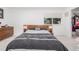 Spacious bedroom featuring a large bed with modern decor and a bright window at 4663 S Lowell Blvd, Denver, CO 80236