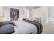 An open closet, comfortable bed, changing table, and neutral decor in a well-lit bedroom at 4663 S Lowell Blvd, Denver, CO 80236