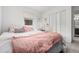 Bedroom featuring natural lighting, plush pillows, and closet storage at 4663 S Lowell Blvd, Denver, CO 80236
