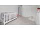 Bright bedroom featuring plush carpeting, a white crib, and ample natural light at 4663 S Lowell Blvd, Denver, CO 80236